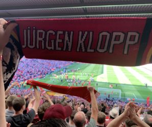 A scarf in front of the Anfield pitch with Jürgen Klopp's name on
