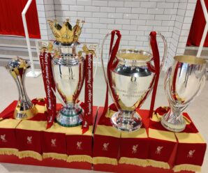 The premier league, champions league, club world cup and super cup trophies on display at anfield
