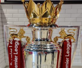 premier league trophy with red ribbons