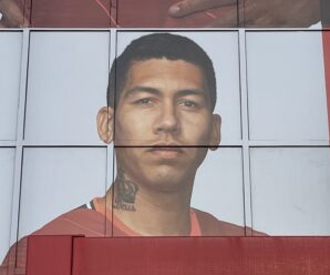 roberto firmino on the side of the kop in his liverpool shirt