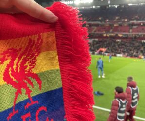 rainbow scarf in front of the pitch at anfield.