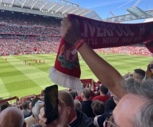 Scarf aloft during You'll Never Walk Alone