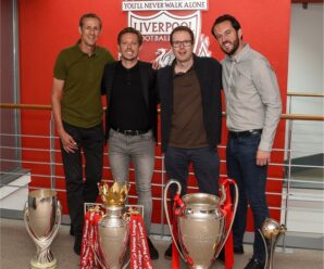 Michael Edwards and team in front of trophies won by Liverpool