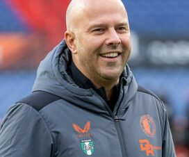 arne slot in a grey feyenoord jacket with orange writing