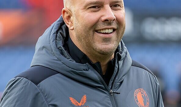 arne slot in a grey feyenoord jacket with orange writing
